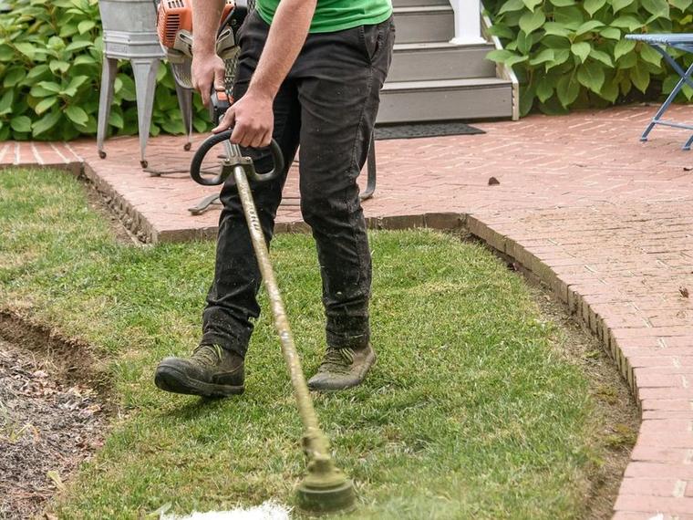 Freshly installed landscaping stone and bed edging on a Green Bay property by Two Guys USA
