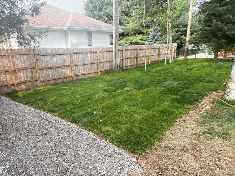 A tree stump ground down flush with the lawn by Two Guys USA in Green Bay